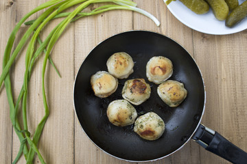 Fried dumplings in a frying pan.