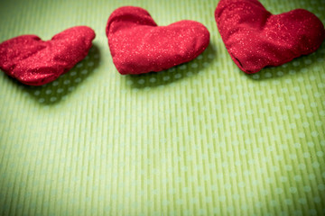Valentines Day. Colorful knitted hearts on a vintage background in polka dots. Red heart. Green background. Valentine's day. Heart pendant. Valentine cards. Eighth of March. International Women's Day.