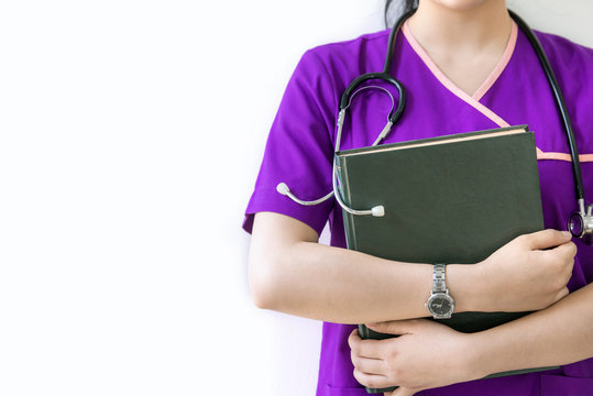 Cropped image of nurse holding green book on white background