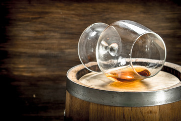Obraz na płótnie Canvas barrel with a glass of cognac.