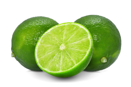 two whole fresh green lime with half isolated on white background