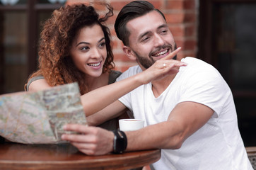 A picture of  tourists looking at map in a cafe