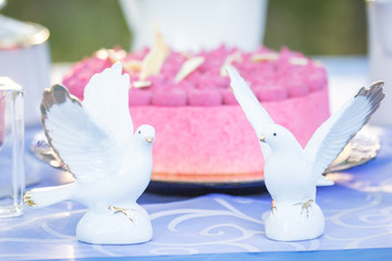 wedding figures and cake on the table