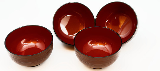 Still life of four Japanese lacquer bowls for miso soup or noodle soup