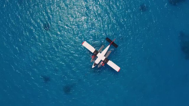 Top view of seaplane at parking. Rotating camera shot of the hydroplane in ocean