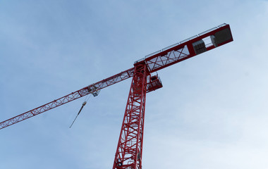 Red high construction crane on a building site, oblique image of an abstract, unengraved image effect