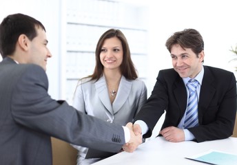 handshake business partners in the workplace
