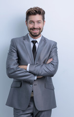 Portrait of a happy business man on a gray background