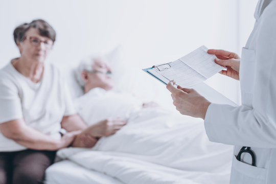 Doctor reading report to patient