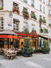 Typical view of the Parisian street with tables of brasserie (cafe) in Paris, France - obrazy, fototapety, plakaty