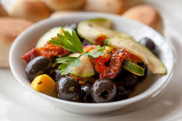 Marinated vegetables: olives, zucchini, tomatoes with yeast buns - apetizer