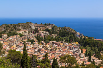 Fototapeta na wymiar Taormina, Sicily, Italy. View of the historic center of the city and the ruins of the ancient Greek theater from a height