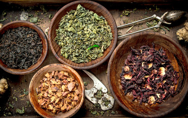 Different kinds of fragrant tea in bowls.