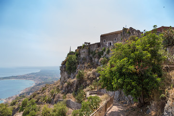 Fototapeta na wymiar Taormina, Sicily, Italy. Church of Madonna della Rocca, towering above the sea coast.