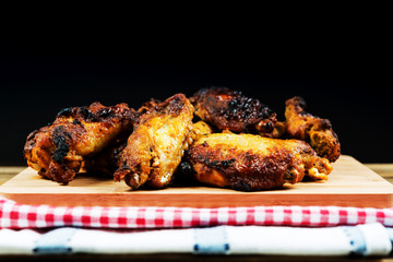 Chicken wings with sauce and golden French fries potatoes