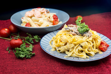 Pasta with pesto sauce and nuts on a the table