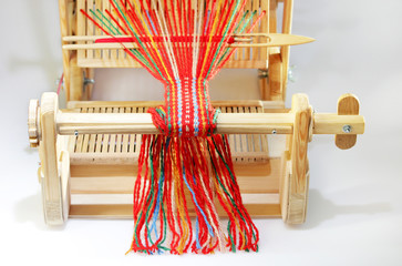 Weaving mini machine for making belts with patterns. Folk art, handmade. Detail.