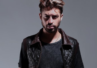 Portrait of a pensive handsome man  over gray background