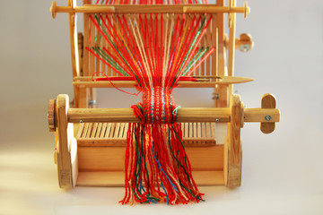 Weaving mini machine for making belts with patterns. Folk art, handmade. Detail.