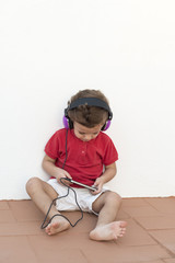 Child with headphones and mobile