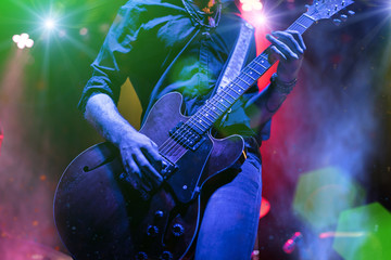 Guitarist playing on electric guitar.