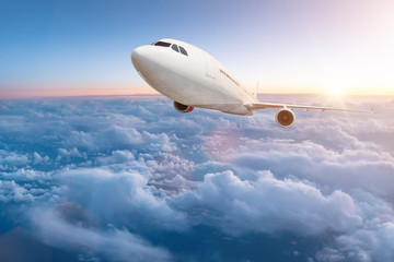 Obraz na płótnie Canvas Commercial airplane flying above clouds.