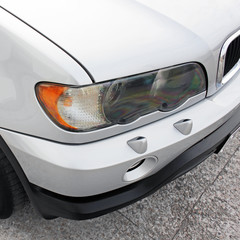 Part of a gray car on a background of asphalt.