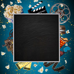 Obraz premium Cinema concept of vintage film reels, clapperboard and other tools.