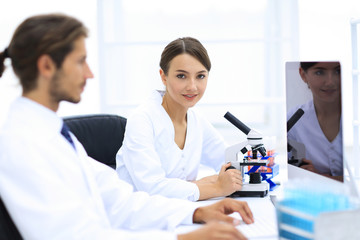 Lab expert working on a test using microscope