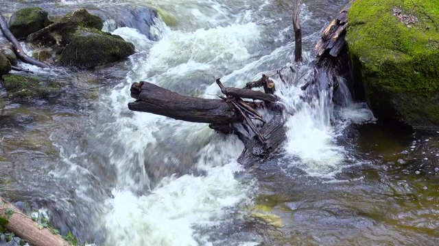 Mountain river, water flowing over rocks and boulders