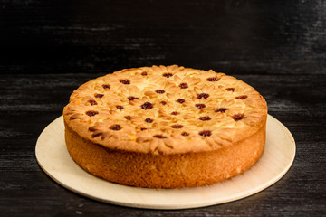 cake with curd filling on a black wooden background
