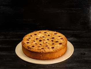 cake with curd filling on a black wooden background