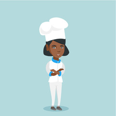 Cheerful african-american chief cook in uniform and hat standing with arms crossed. Full length of young smiling female chief cook with folded arms. Vector cartoon illustration. Square layout.