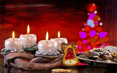 Advent Wreath with Burning Candles on the Red Background