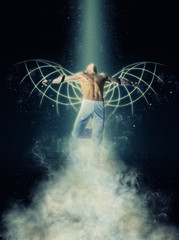 A man with wings on a background of dark sky