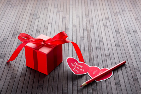 Heart-shaped Valentine's day greeting card and red present box