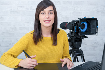 Naklejka premium young woman designer using graphics tablet for video editing