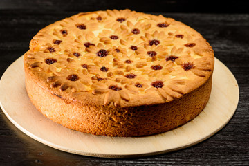 cake with curd filling on a black wooden background