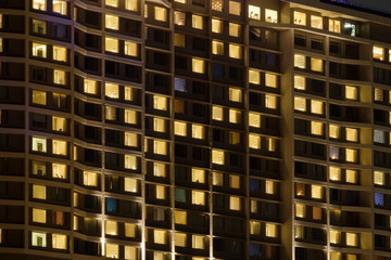 Fototapeta na wymiar Apartment building / Exterior view of apartment building at night.