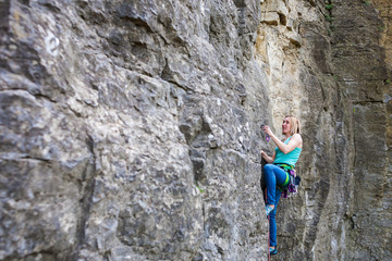 Fototapeta premium A woman climber on a rock.