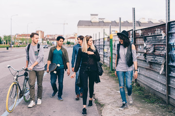 group of friends multiethnic walking outdoor having fun - friendship, interaction, getting away form it all concept