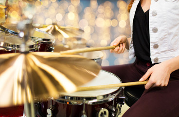 close up of woman drummer playing drum kit