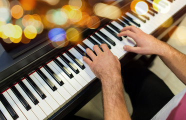 close up of male hands playing piano