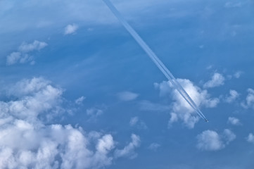 Airplane flying at high altitude near the clouds