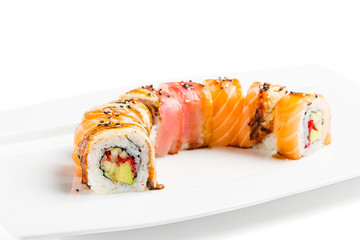 Colorful sushi roll with salmon, eel, tuna, avocado, cucumber, caviar tobica