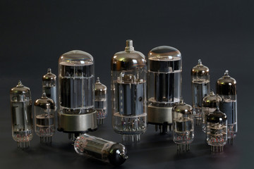Radio tubes of different sizes on a gray background