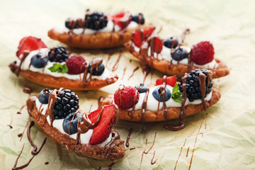 Tartlets with berries on parchment paper