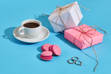 Valentine's day greeting card. White coffee cup, pink macaroons 