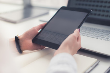 Young women using digital tablet in the office