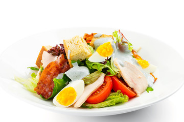 Fresh green salad with chicken, bacon, eggs, tomatoes and croutons